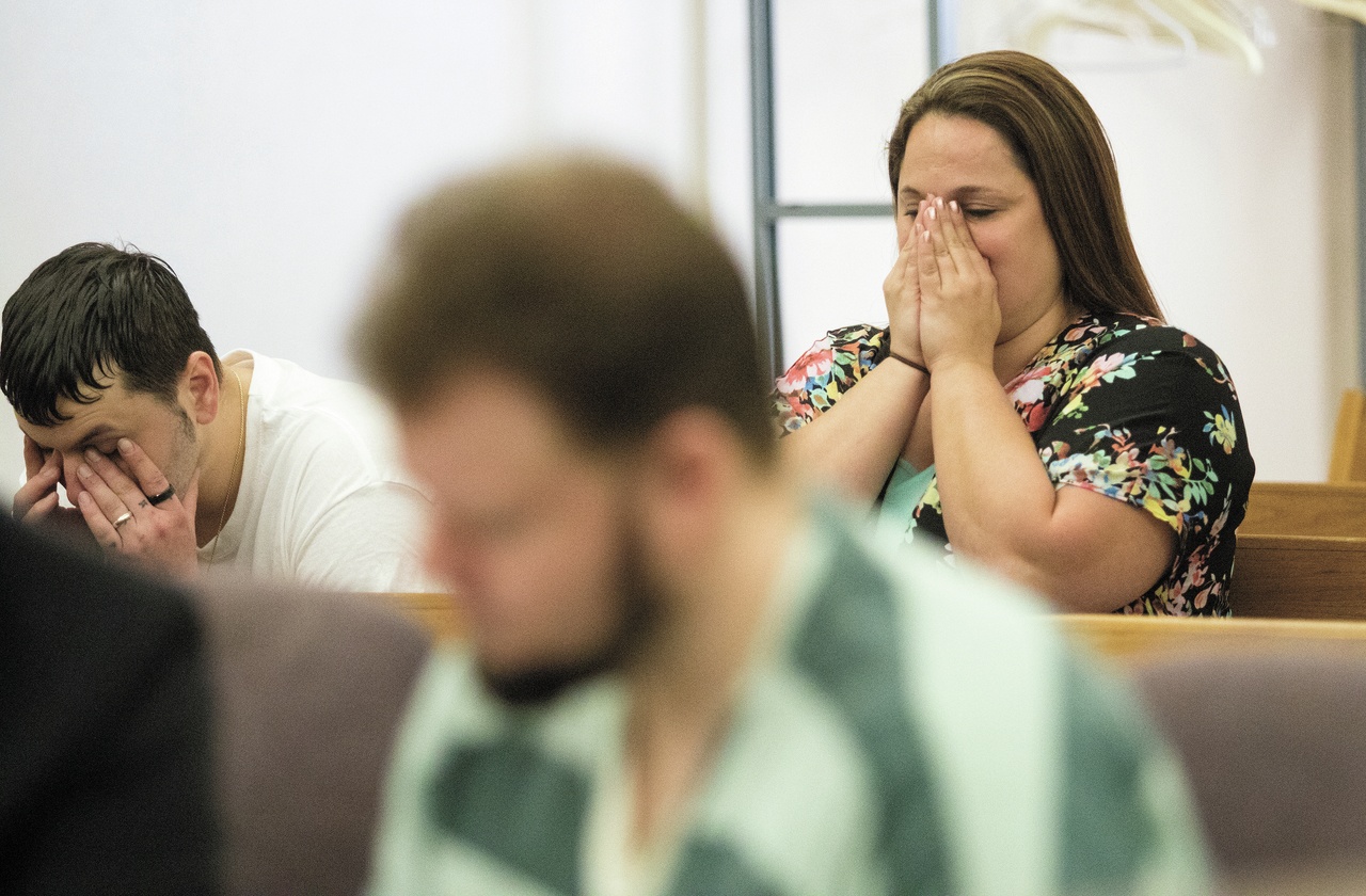 Matthew Steadman rubs his face as his sister, Tabitha, prepares to make a statement Monday at the Snohomish County Courthouse during the sentencing of Michael Stowell for the murder of their father, Steven Steadman.