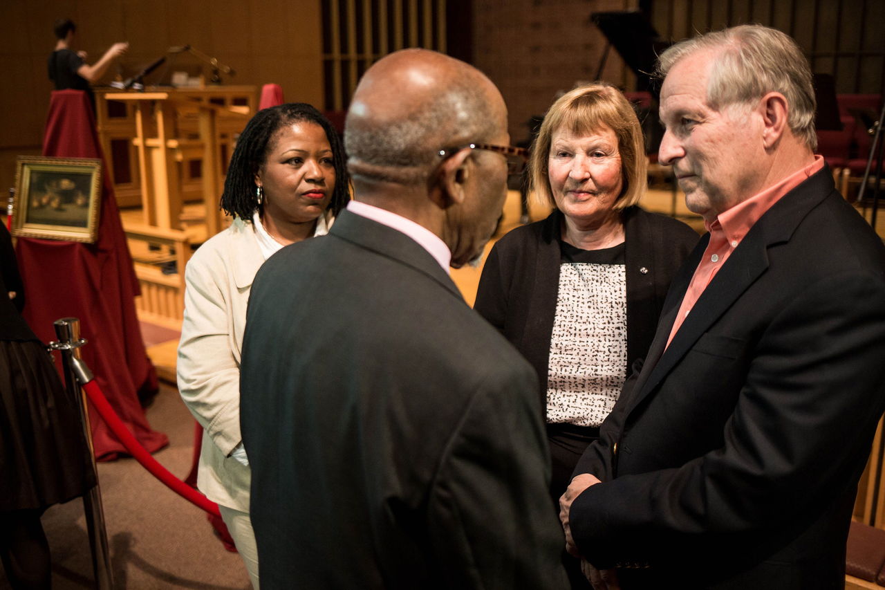 Mukilteo’s William Sacherek (right) and Liselotte Lamerdin (center right) donate two rare paintings by African American artist Charles Ethan Porter to Dr. John Perkins (center left), of Seattle Pacific University’s John Perkins Center, on Tuesday at First Free Methodist Church in Seattle, Washington. The paintings represent the school’s first acquisition of art since SPU President Dan Martin’s directive to create and shape a university art collection.