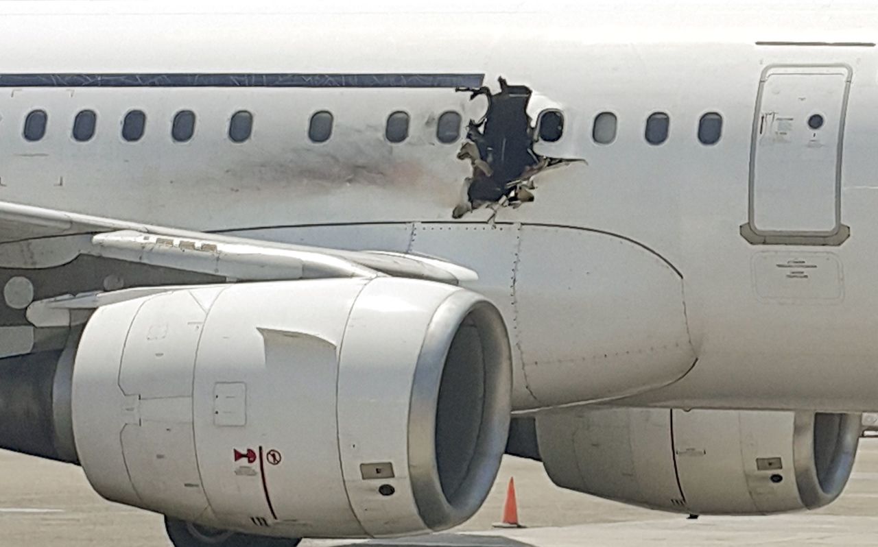 A hole is seen in an Airbus A321 operated by Daallo Airlines as it sits on the runway in Mogadishu, Somalia, on Feb. 2.