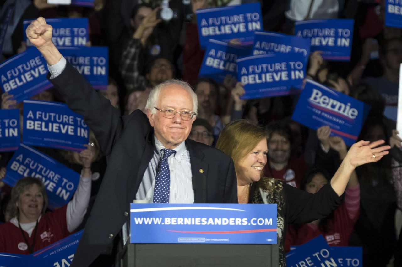 Democratic Presidential Candidate, Sen. Bernie Sanders, I-Vt, and his wife, Jane, acknowledge the crowd as he arrives for his caucus night rally Monday in Des Moines, Iowa.