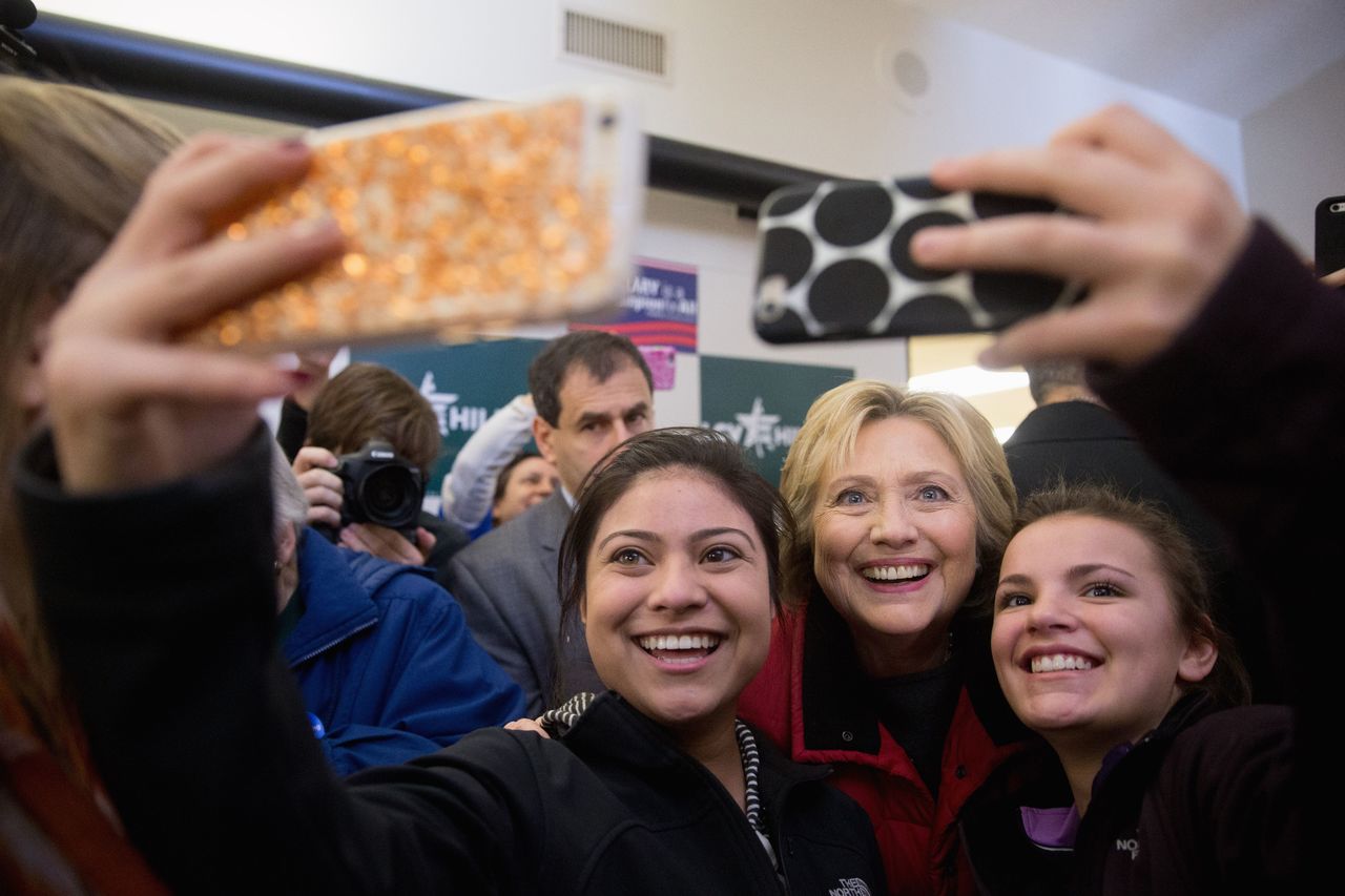 Democratic presidential candidate Hillary Clinton takes photos with workers at her campaign office in Des Moines, Iowa, on Monday.