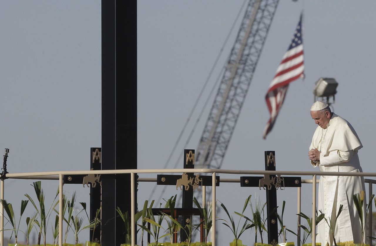 Pope Francis prays near the U.S.-Mexico border fence along the Rio Grande in Ciudad Juarez, Mexico, on Wednesday.