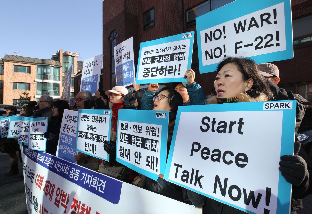 South Korean protesters stage a rally to oppose U.S. F-22 stealth fighters’ arrival in South Korea, near the presidential house in Seoul, South Korea, on Wednesday. Four U.S. F-22 stealth fighters are flying over South Korea amid growing tensions following North Korea’s rocket launch. The signs read “ Oppose the arrival of F-22 stealth fighters and the possible deployment of the United States’ advanced defense system THAAD.”