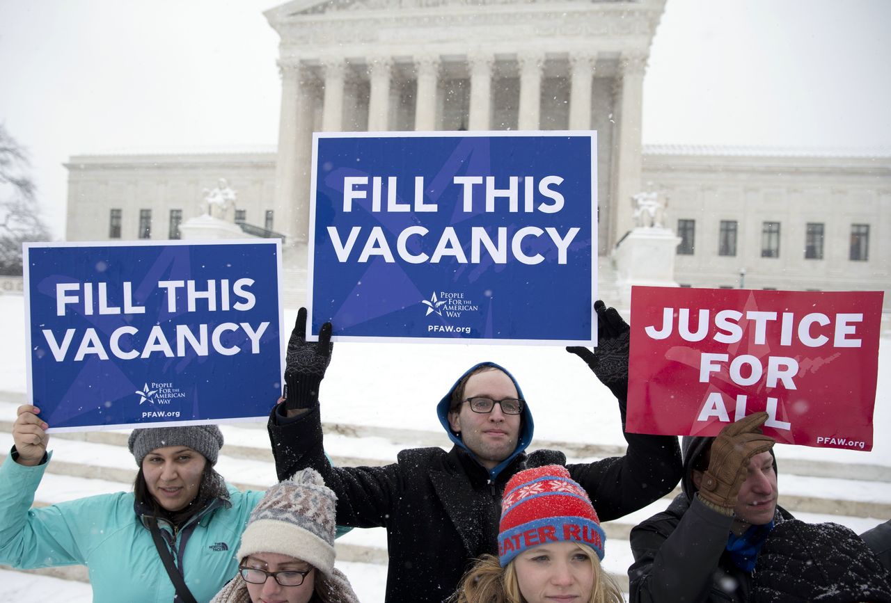 A group with “People for the American Way,” from Washington, gather with signs in front of the U.S. Supreme Court in Washington on Monday as they call for Congress to give fair consideration to any nomination put forth by President Barack Obama to fill the seat of Antonin Scalia.