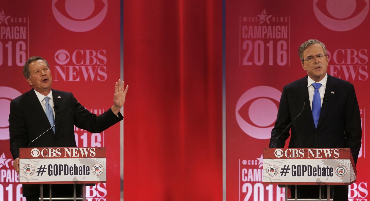 Republican presidential candidate John Kasich (left), speaks as Jeb Bush listens during the CBS News Republican presidential debate Saturday in Greenville, South Carolina.