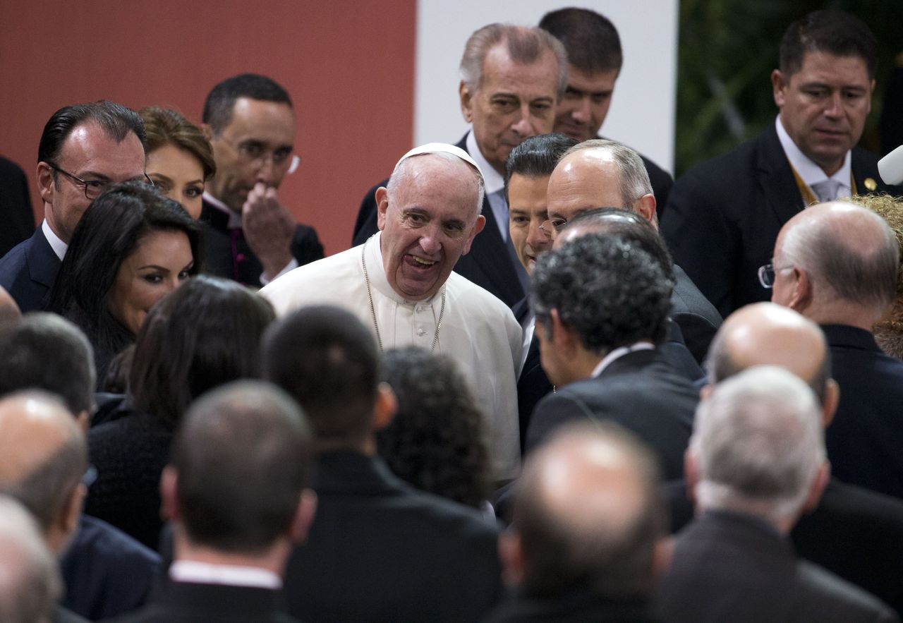 Pope Francis greets invited guests after a welcoming ceremony at the National Palace in Mexico City on Saturday.