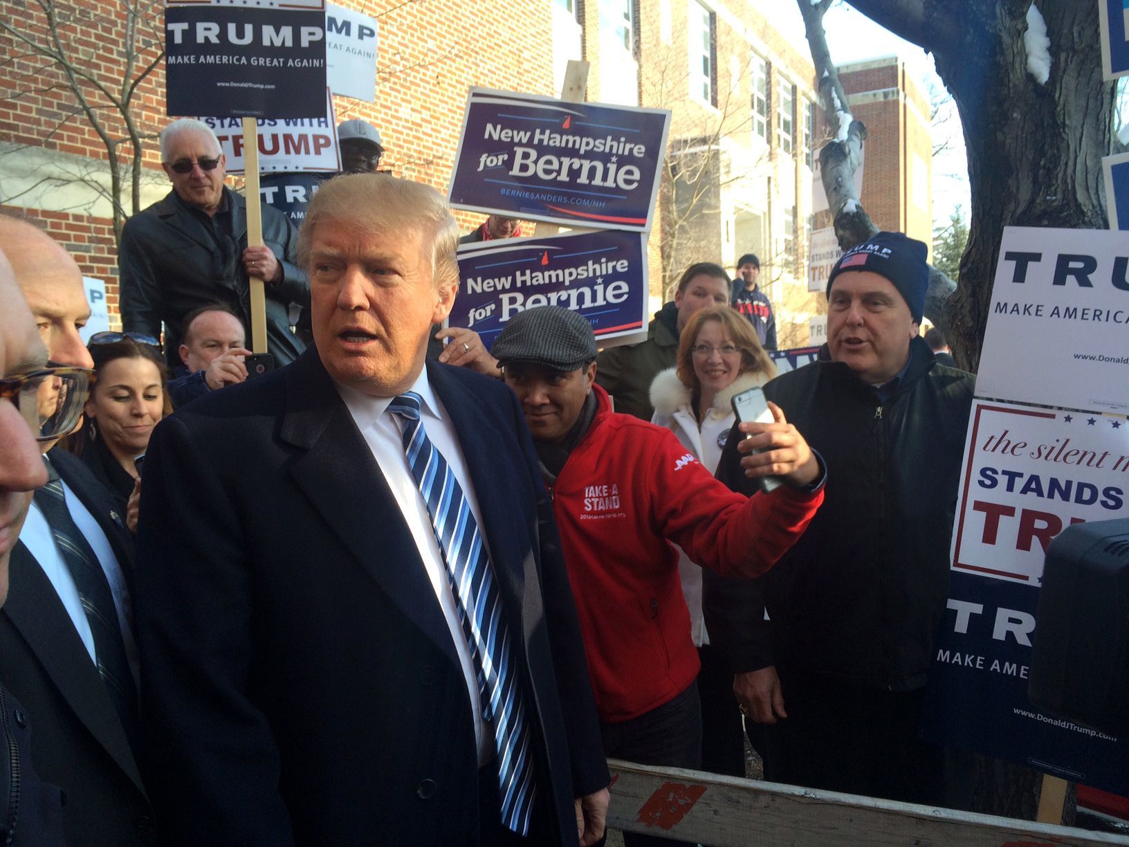 Donald Trumps greets voters at Webster Elementary School in Manchester, New Hampshire, on Tuesday.