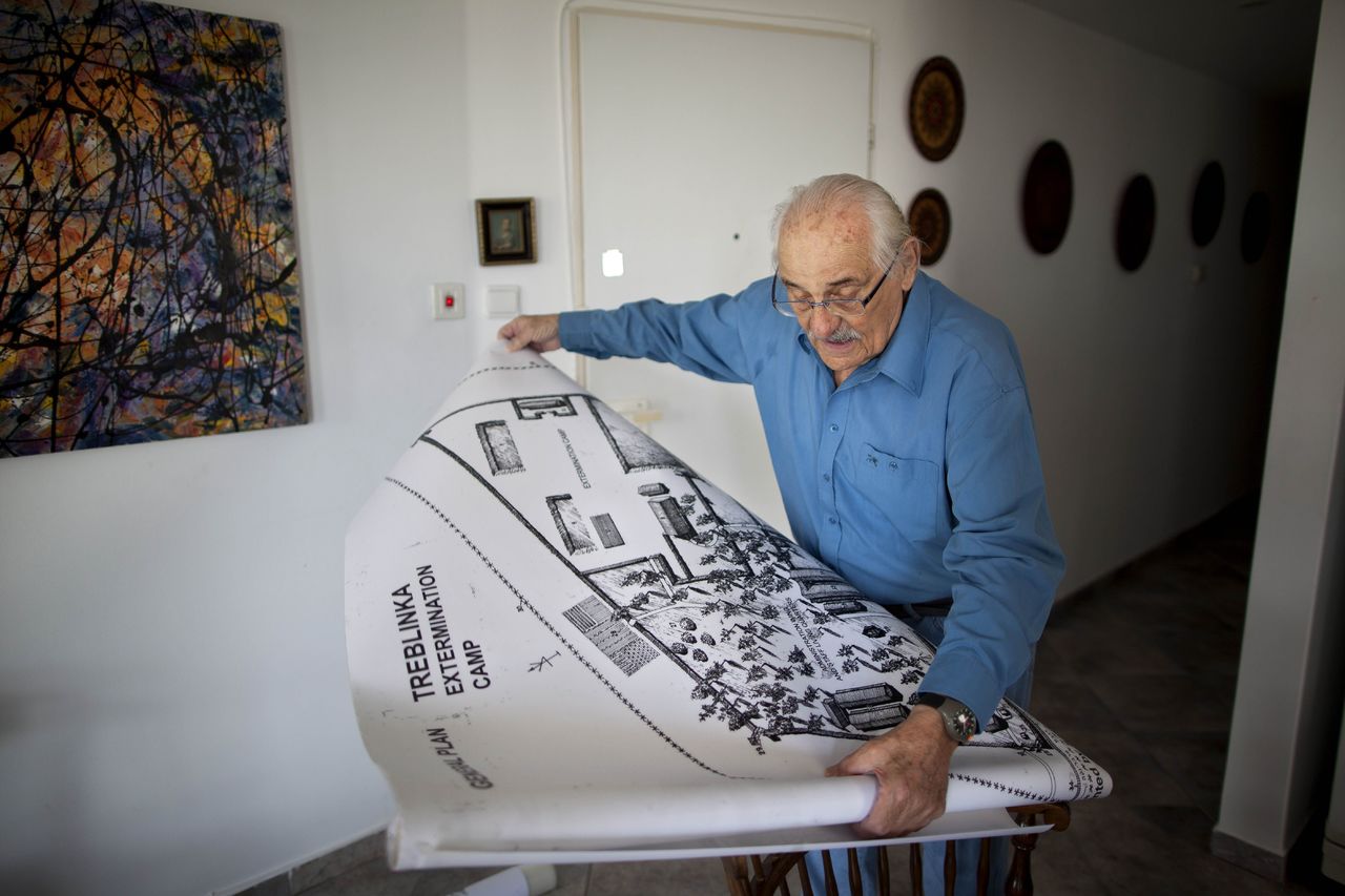 Holocaust survivor Samuel Willenberg displays a map of the Treblinka extermination camp during an interview at his home in Tel Aviv, Israel, in 2010.