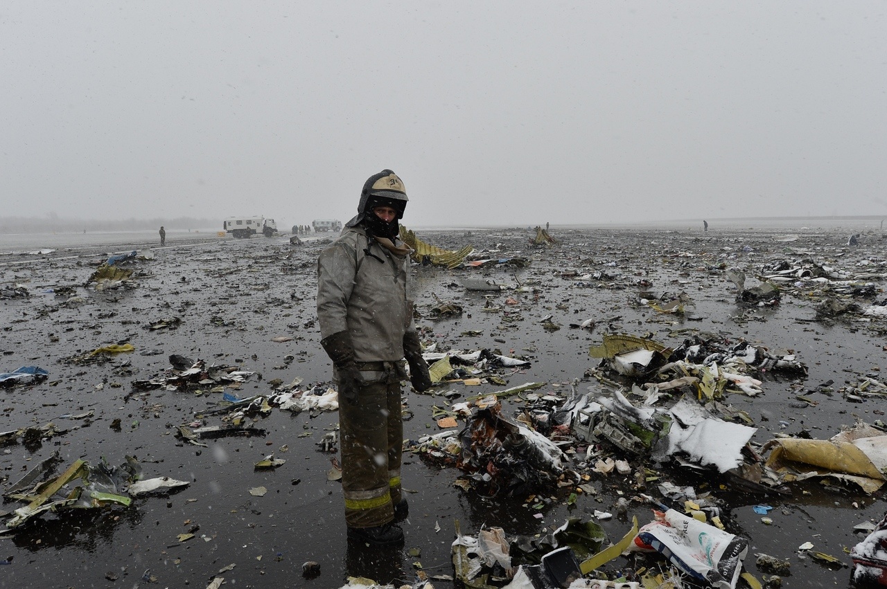 A Emergency Ministry employee stands among the wreckage of a crashed 737-800 airliner at the Rostov-on-Don airport Saturday.