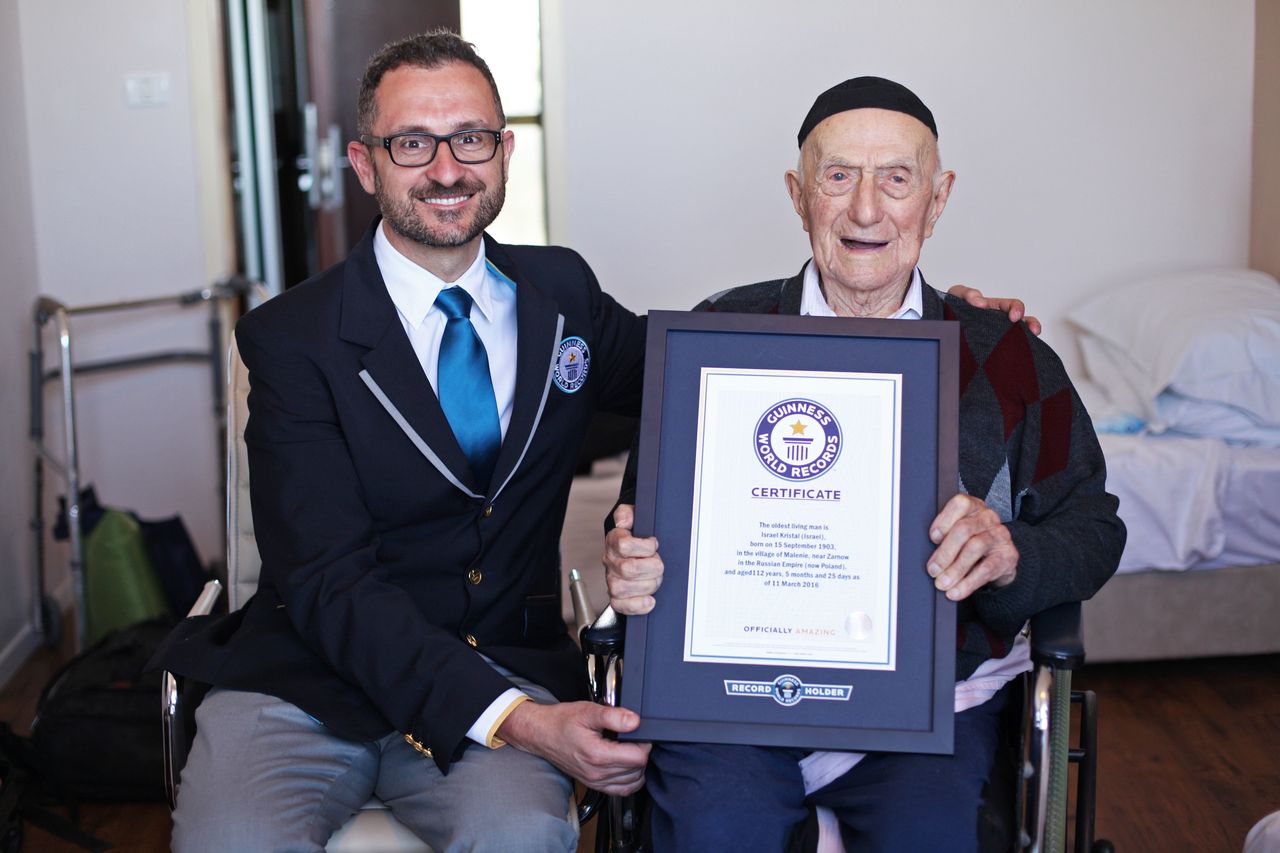 Marco Frigatti, head of records for Guinness World Records, presents Israel Kristal a certificate for being the oldest living man, in Haifa, Israel, on Friday.