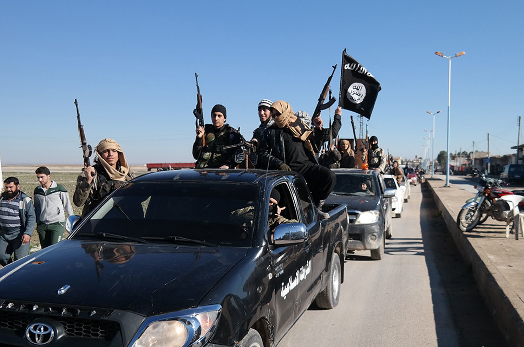 Islamic State militants parade in Tel Abyad, Syria, in 2015.