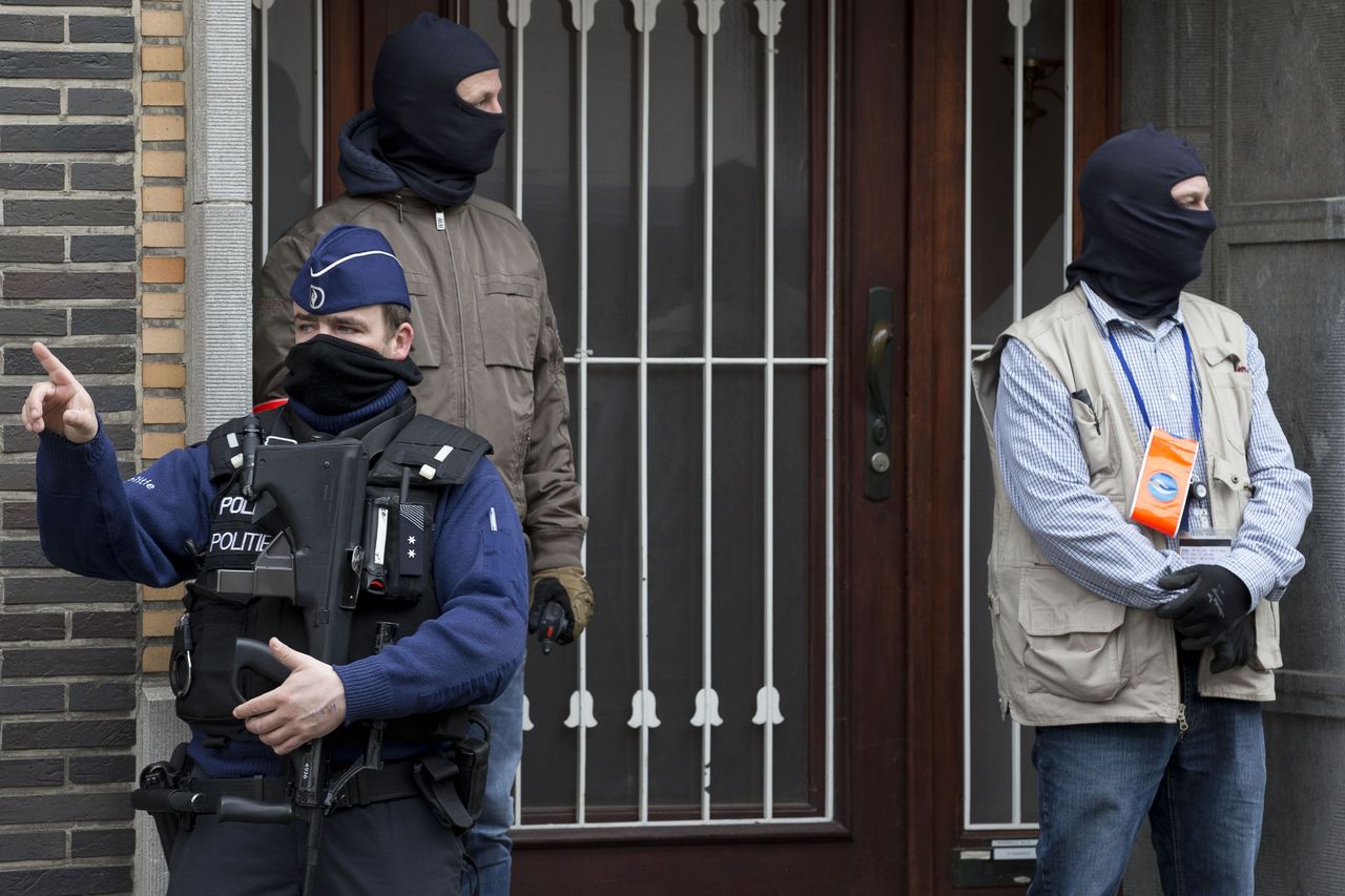 Belgium police stand guard during an investigation in a house in the Anderlecht neighborhood in Brussels, Belgium, on Wednesday.
