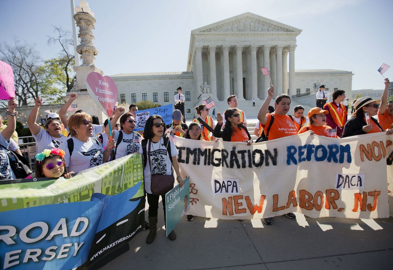 Supporters of fair immigration reform gather in front of the Supreme Court in Washington on Monday. The Court is taking up an important dispute over immigration that could affect millions of people who are living in the country illegally. The Obama administration is asking the justices in arguments today to allow it to put in place two programs that could shield roughly 4 million people from deportation and make them eligible to work in the United States.