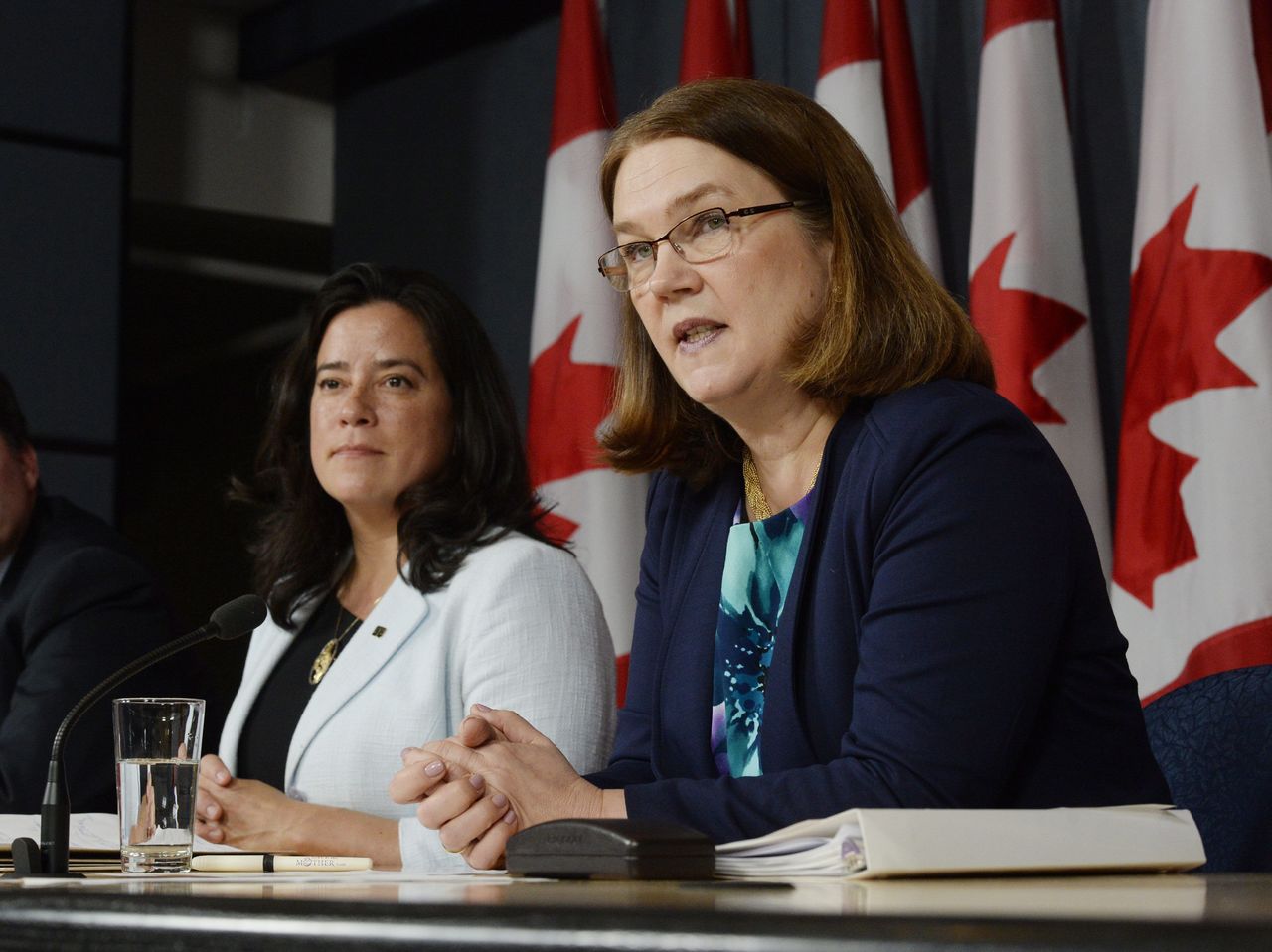 Canada’s Health Minister Jane Philpott (right) speaks as Justice Minister Jody Wilson-Raybould listens at a news conference in Ottawa on Thursday. Canada has introduced a new assisted suicide law that will only apply to Canadians and residents, meaning Americans won’t be able to travel to Canada to die. Visitors will be excluded under the proposed law announced Thursday, precluding the prospect of suicide tourism. Canadian government officials said to take advantage of the law the person would have to be eligible for health services in Canada.
