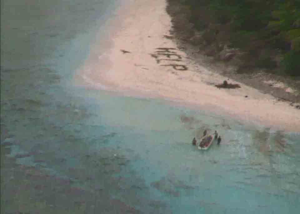 A small boat from Pulap recovers three men from the uninhabited island of Fanadik after they were discovered by a Navy plane.