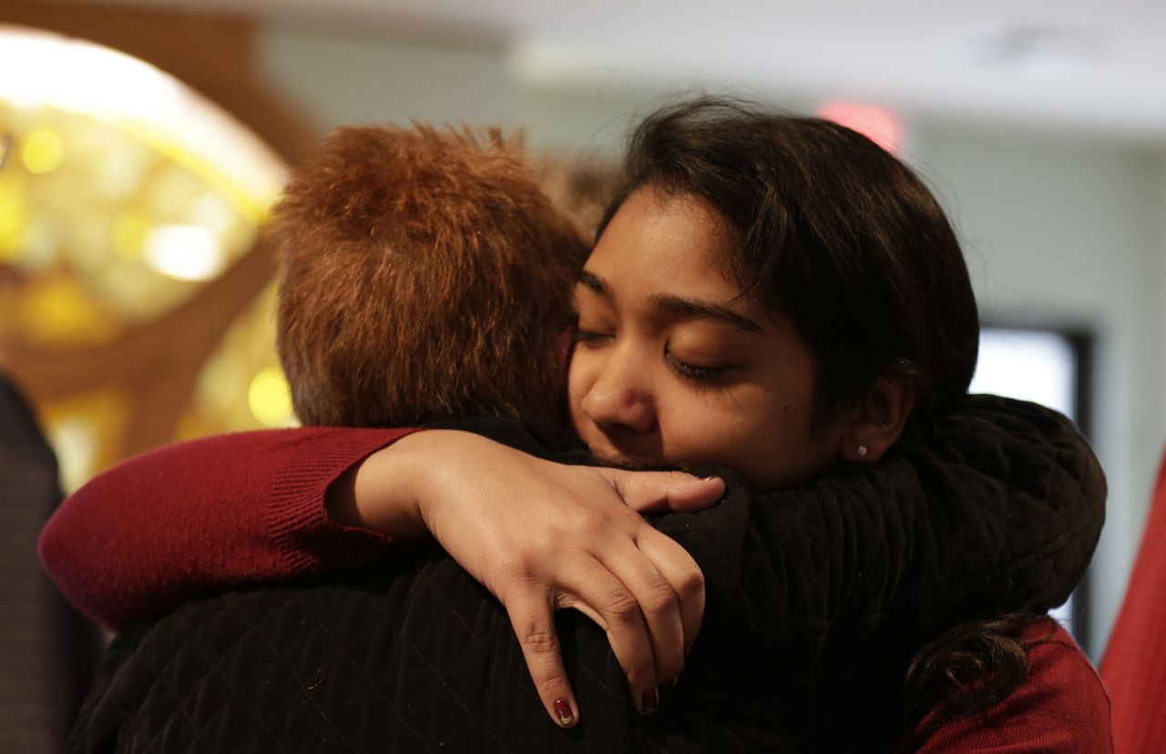 Nikita Deep, 16, embraces a family friend at Antigo United Methodist Church following a morning service Sunday in Antigo, Wisconsin. According to police, Jakob E. Wagner, 18, opened fire with a high-powered rifle outside of the a prom at Antigo High School late Saturday. Deep is class president at the school and was involved in the coordination of the prom.