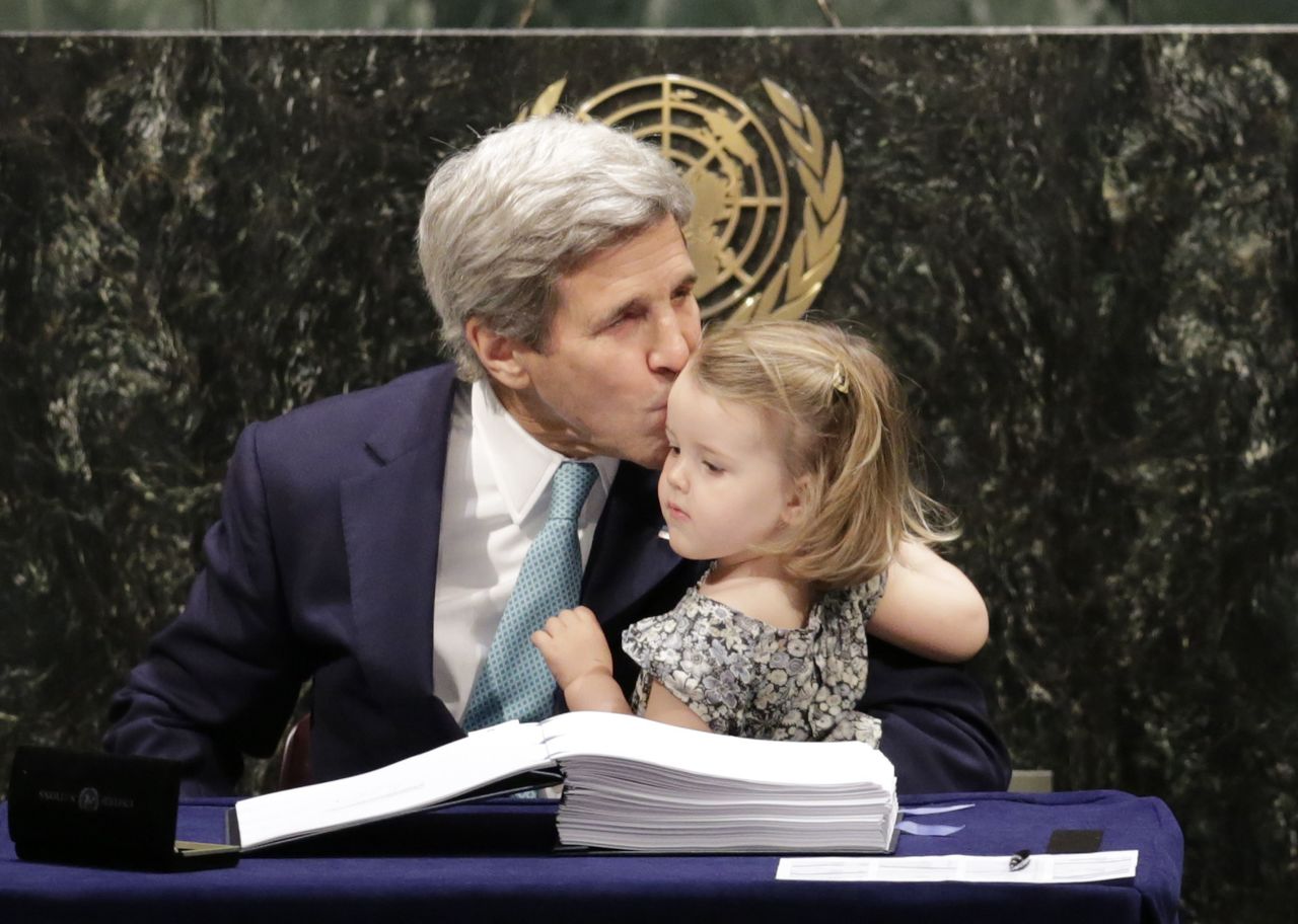 Secretary of State John Kerry kisses his granddaughter after signing the Paris Agreement on climate change Friday at U.N. headquarters.