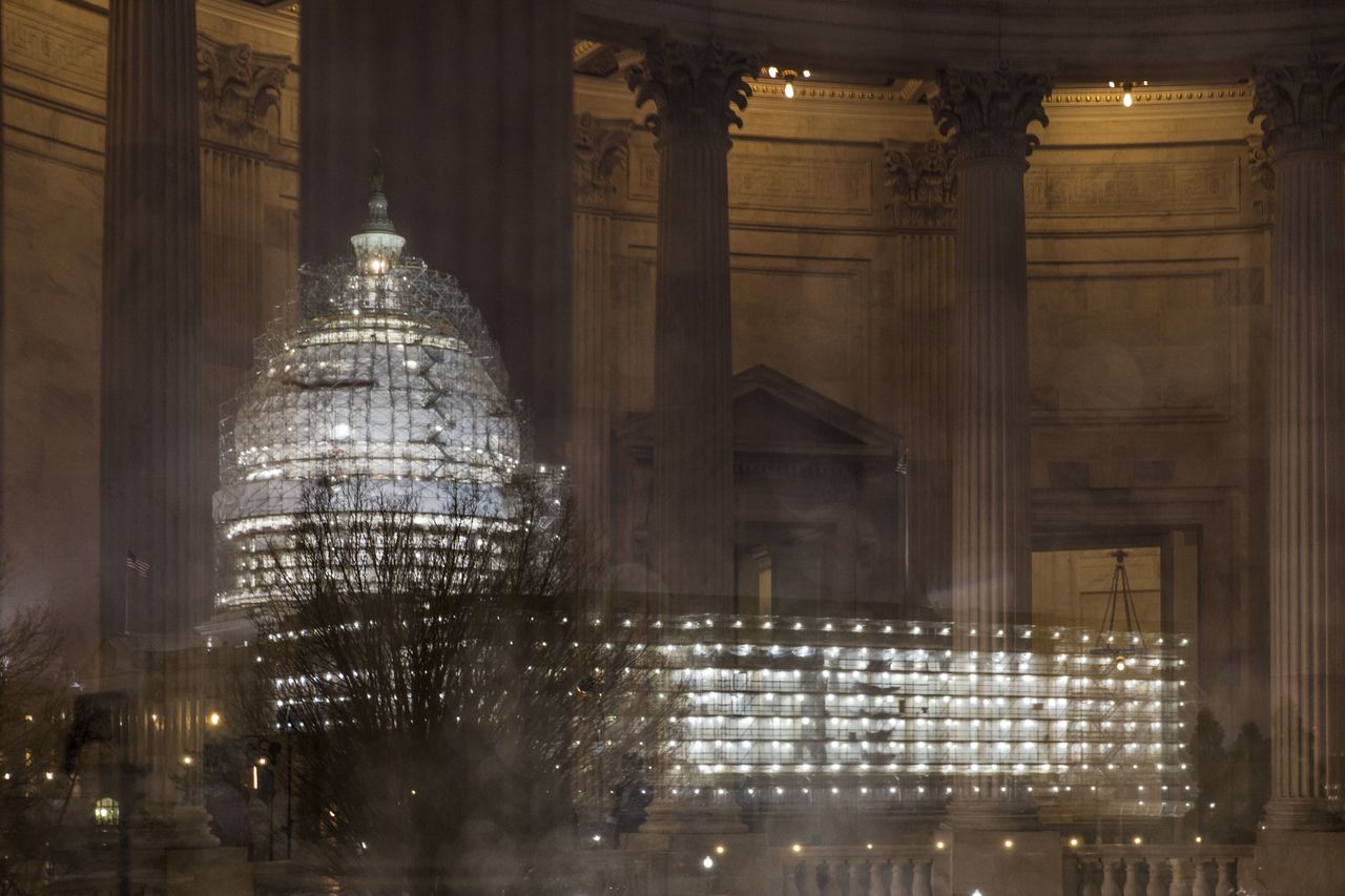 The Capitol in Washington is illuminated during a thunderstorm Feb. 24, with the rotunda of the Russell Senate Office Building reflected on the rain-covered windows. Congress increasingly is defined by what it’s not doing this election year.