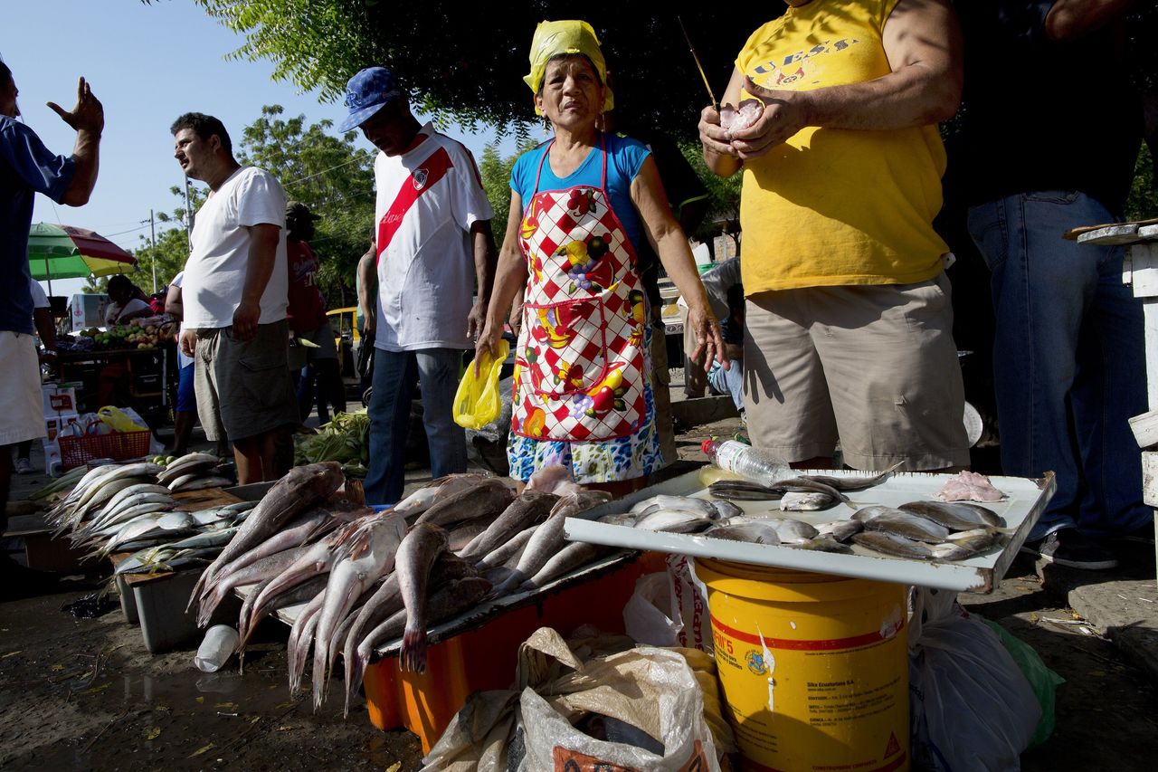 Vendors sell fish in a makeshift market, set up near the business district which was severely damaged by a 7.8-magnitude earthquake, in Manta, Ecuador on Wednesday. Businesses are slowly opening, although electricity and running water are still scarce in the Pacific coastal city.