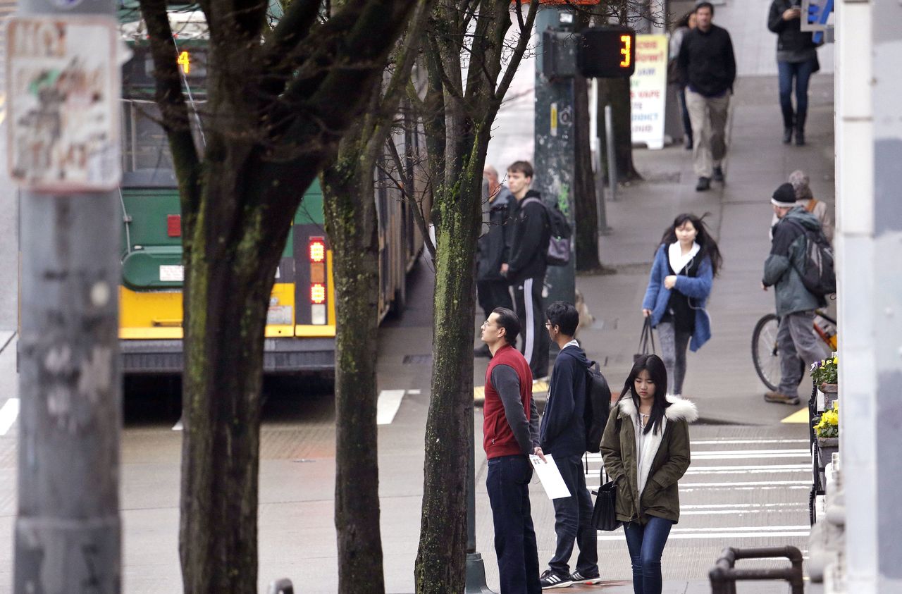 Pedestrians wait to cross streets in Seattle’s University District neighborhoodon Jan. 27. Across the country, just 14 percent of neighborhoods manage to be at once affordably priced, walkable and near decent schools. And many of those neighborhoods exist in only two cities: Washington and Seattle, according to a new analysis released Wednesday by the real estate brokerage Redfin.
