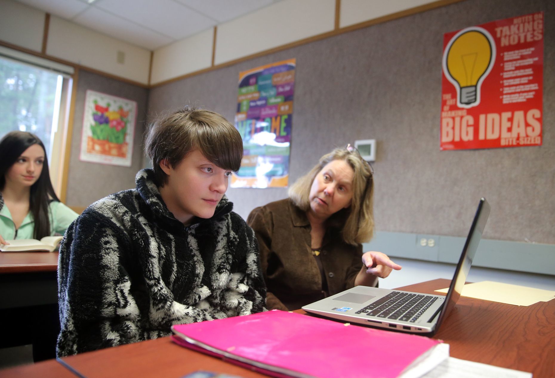 Summer Blackwell (left) works with teacher Diane Clouser on her reading assignment in English class in Bremerton on Feb. 4. She has risen to the challenge and is thriving in her mainstream classes.