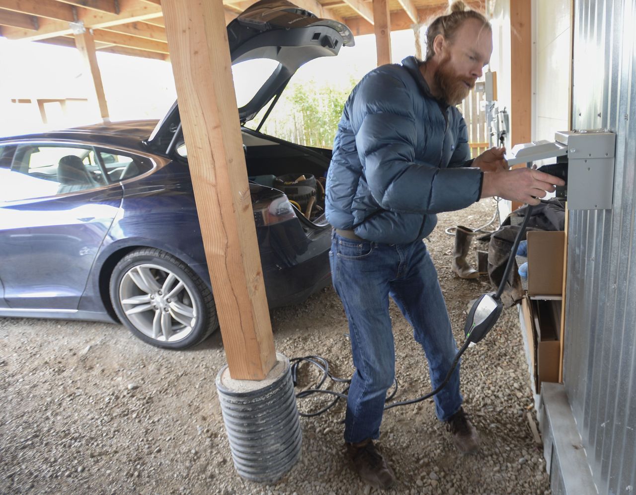 Ted Clifton plugs the charger for his Tesla into his solar-powered house in Bellingham on March 2.