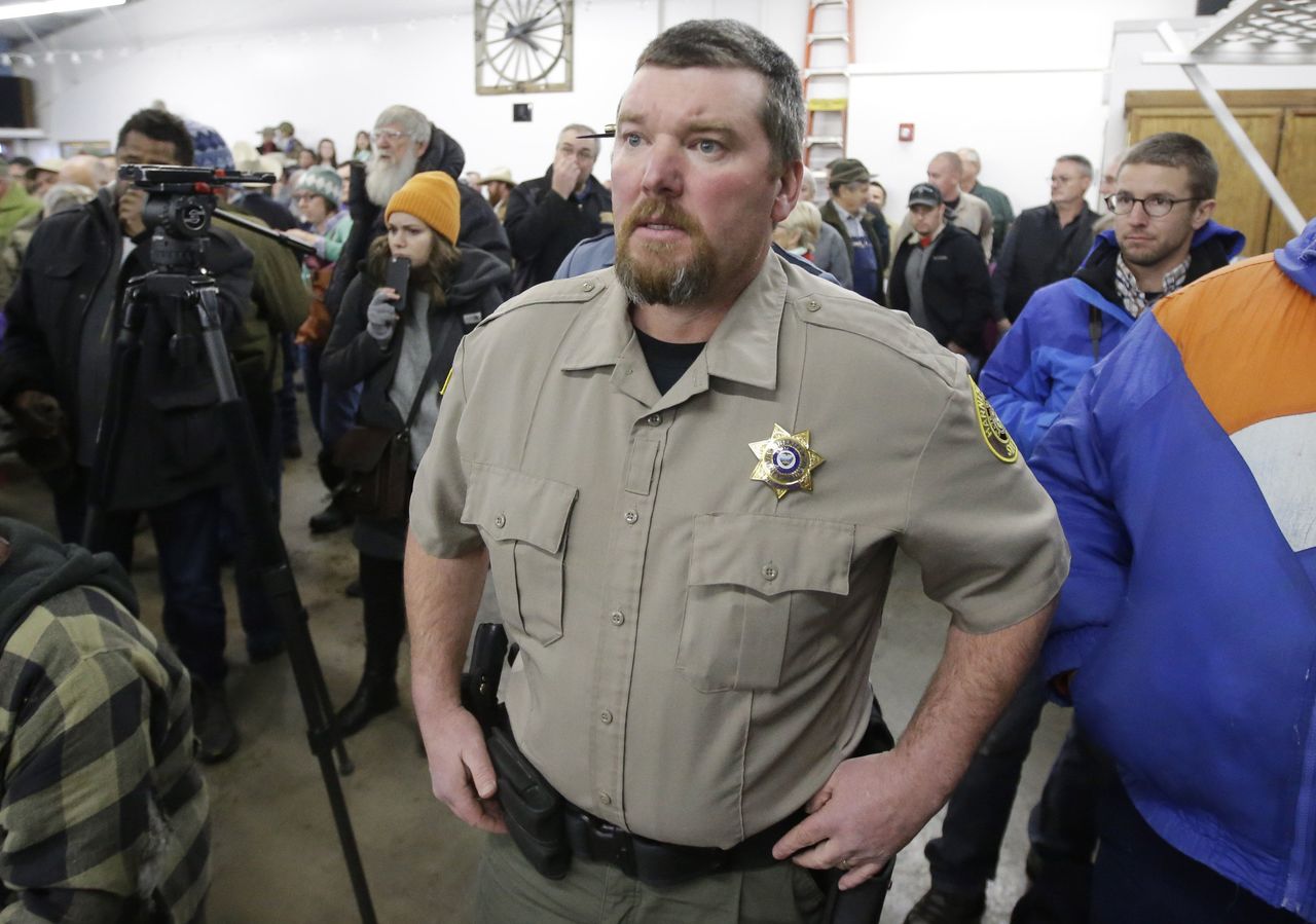 In this Jan. 6, 2016, photo, Harney County Sheriff David Ward arrives at a community meeting at the Harney County fairgrounds in Burns, Oregon. Ward, whose jurisdiction includes the Malheur National Wildlife Refuge, cooperated with federal and state police and became one of the public faces of the standoff. He urged standoff leader Ammon Bundy and his followers to stand down and respect the law.