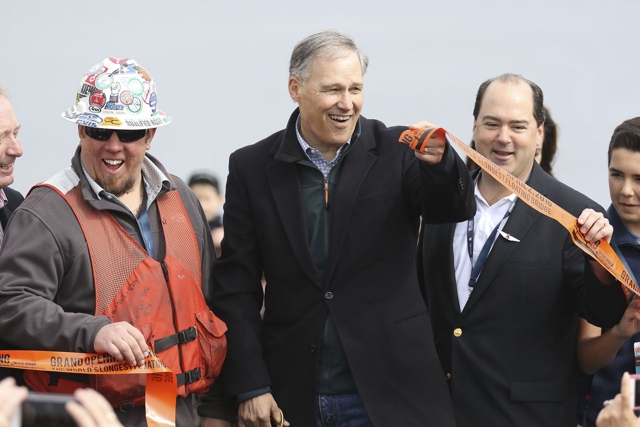 Gov. Jay Inslee cuts the ribbon to open the new 520 floating bridge Saturday morning in Seattle.