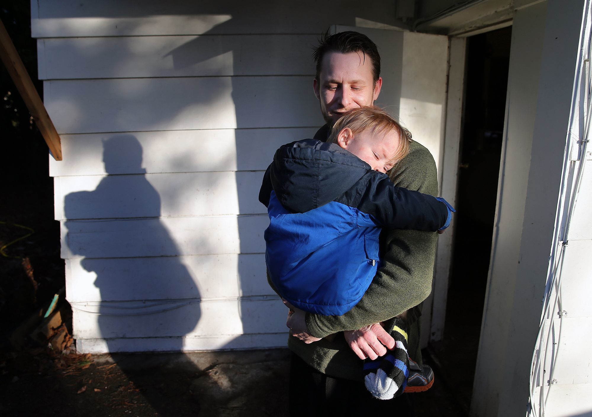 In this undated photo, Matthew Daigneault holds onto his son Aden, 1, outside of his rental home in West Bremerton. Once-cheap houses and apartment buildings like Admiral Manor are being renovated and rented at higher rates. Some federally subsidized developments have been converted to market-rate rentals, eating away at the county’s stockpile of affordable units.