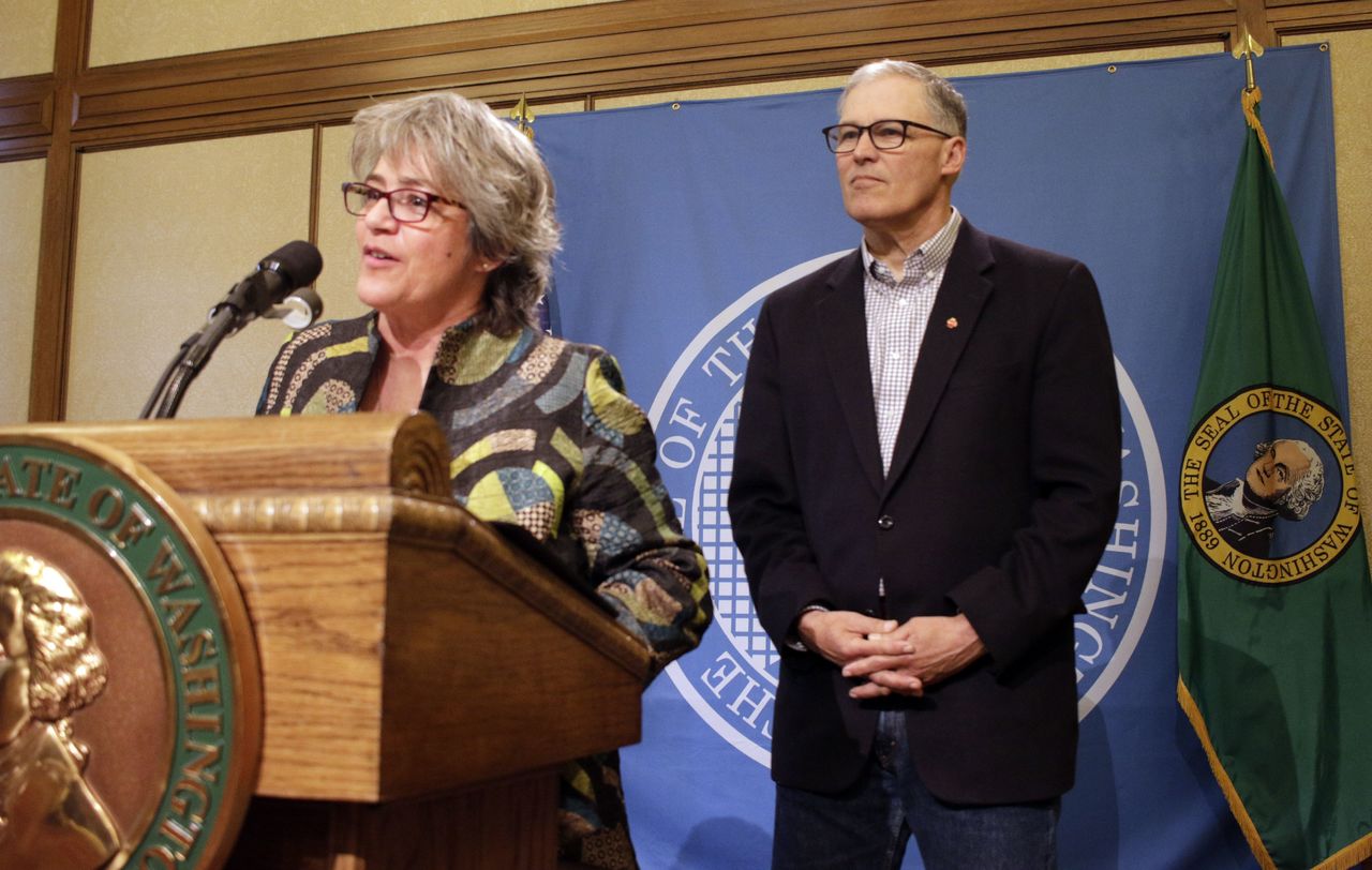 Cheryl Strange, the new head of Western State Hospital, talks to the media as Gov. Jay Inslee looks on during a news conference, Tuesday in Olympia. Strange replaces former Western State Chief Executive Officer Ron Adler, who was fired after a man charged with murder escaped from the facility last week, the latest in a litany of problems at the 800-bed hospital in Lakewood.