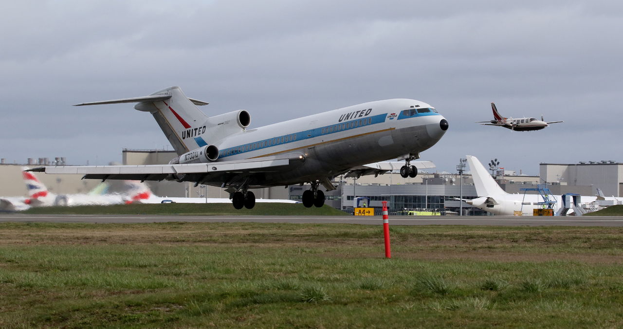 A chase plane flies alongside the first Boeing 727 as it takes off from Paine Field in Everett on Wednesday, en route to Boeing Field in Seattle and a permanent home at the Museum of Flight there.