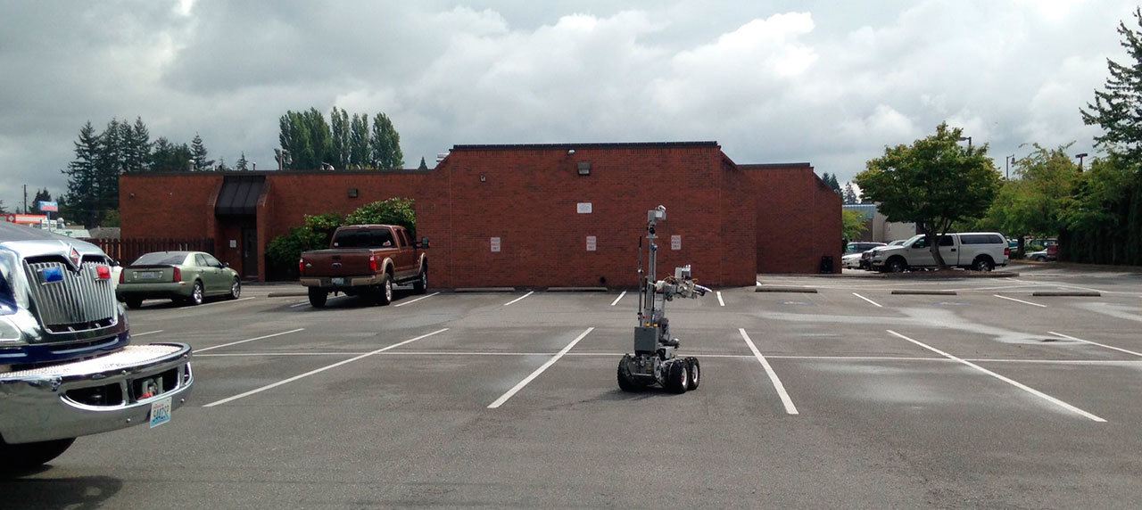The bomb squad robot rolls toward the Marysville Municipal Court building to check out a suspicious package. (Marysville Police Dept.)