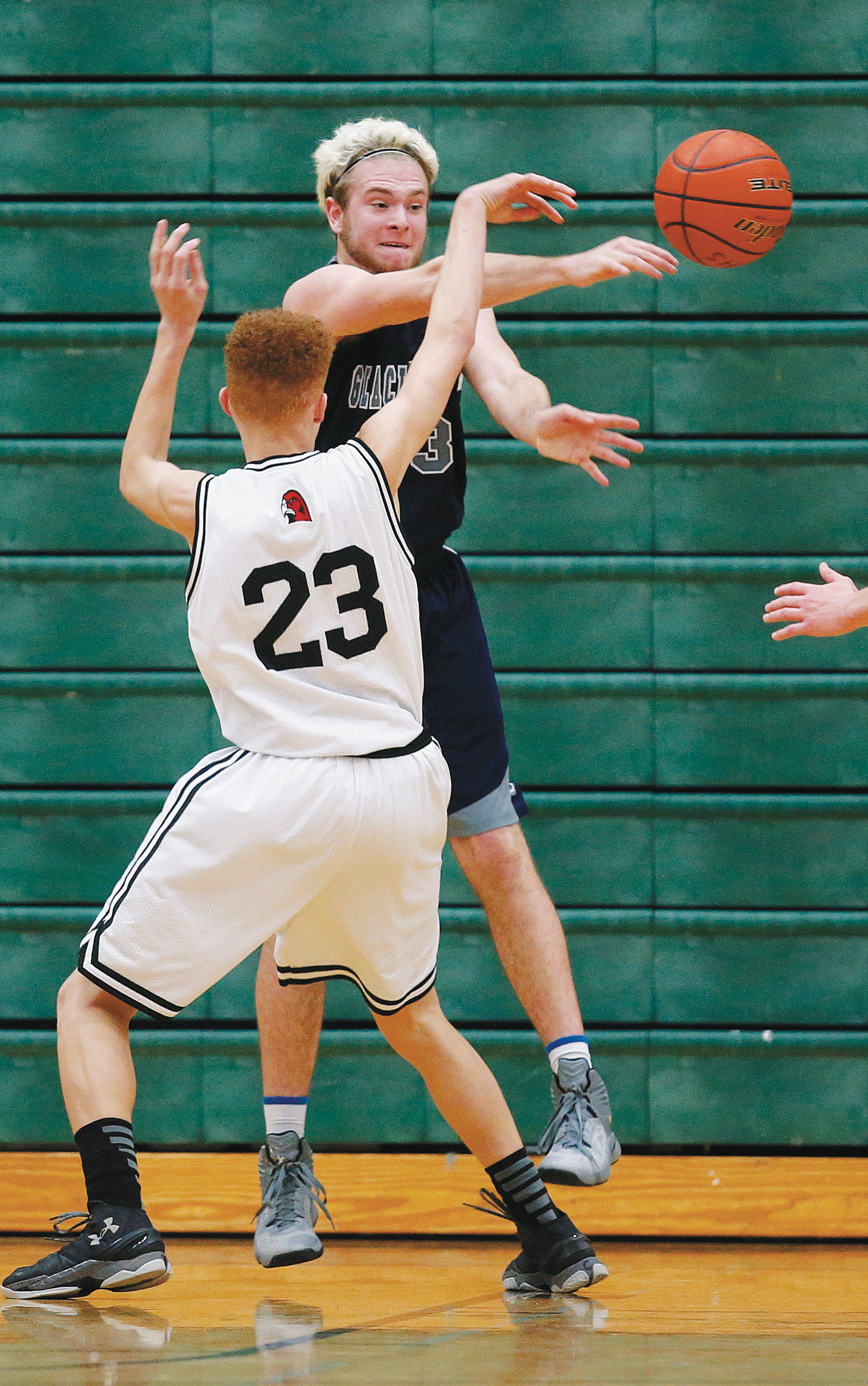 Glacier Peak’s Kyle Dvorak (rear) defends Mountlake Terrace’s Khyree Armstead during a 3A District 1 tournament game Tuesday at Jackson High School. Mountlake Terrace beat Glacier Peak 48-44 in overtime.