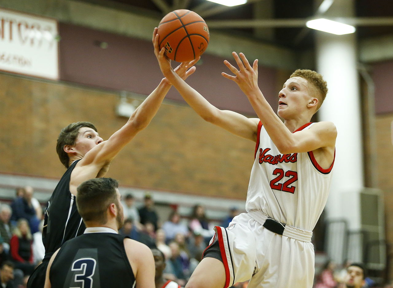 Mountlake Terrace’s Khyree Armstead (22) flies past Arlington defenders for a layup during a District 1 playoff game Friday at Mountlake Terrace High School.