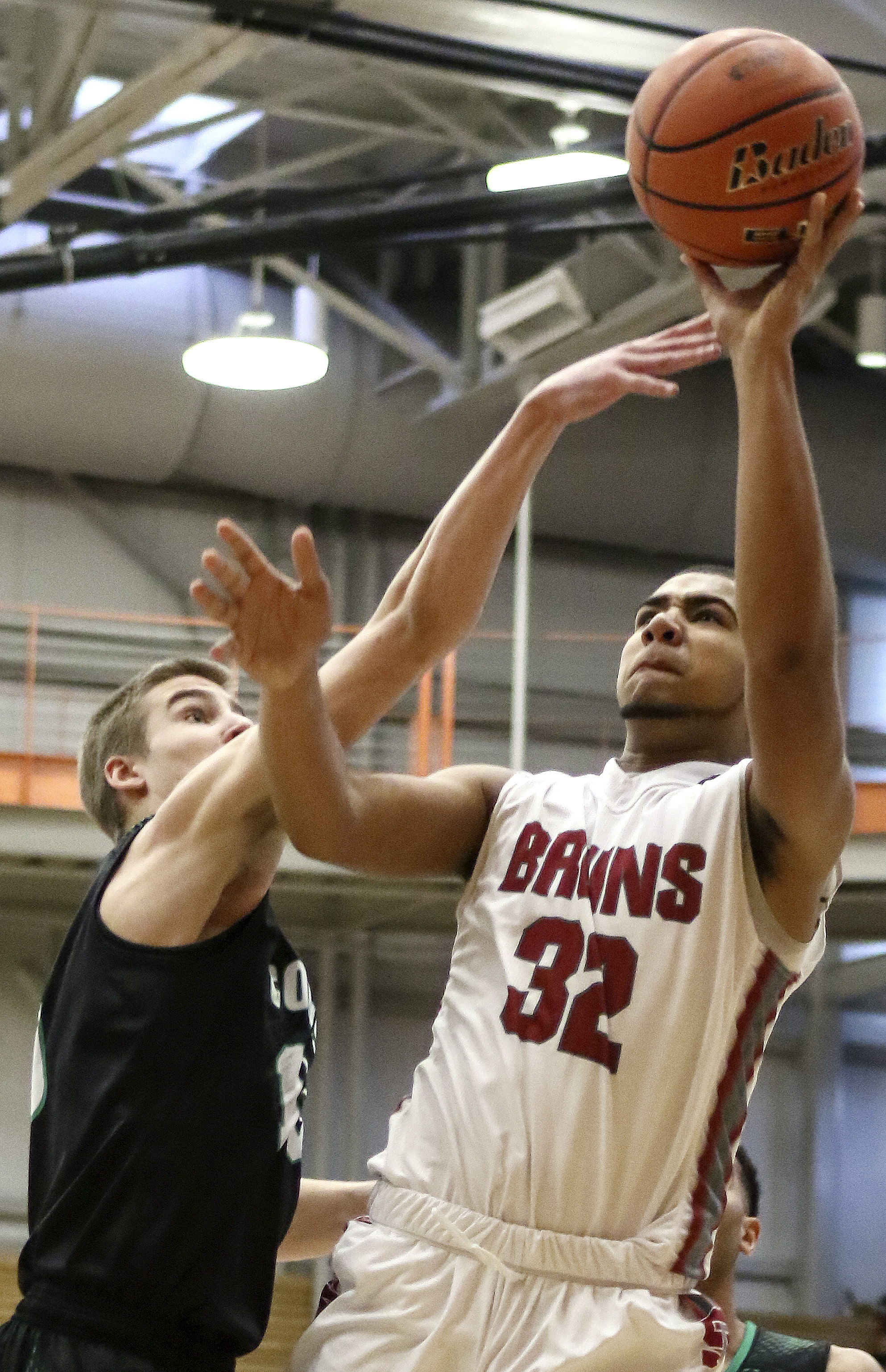 Cascade’s Brennen Hancock attempts a shot over Kentwood’s Beau Roggenbach during a 4A state regional game on Saturday at Everett Community College.