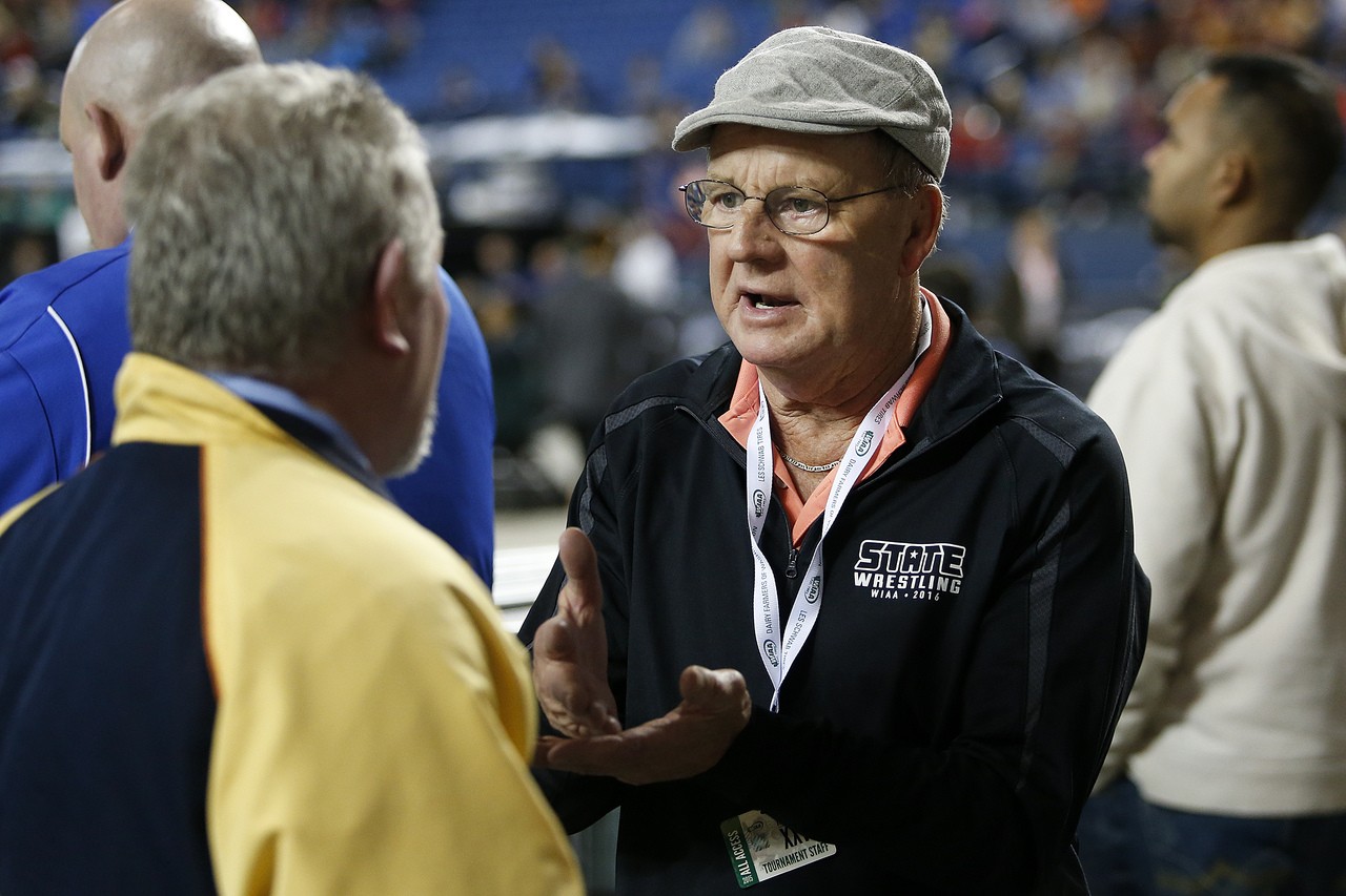 Arlington wrestling coach Rick Iversen (right) announced his retirement following the finals of Mat Classic XXVIII on Saturday.