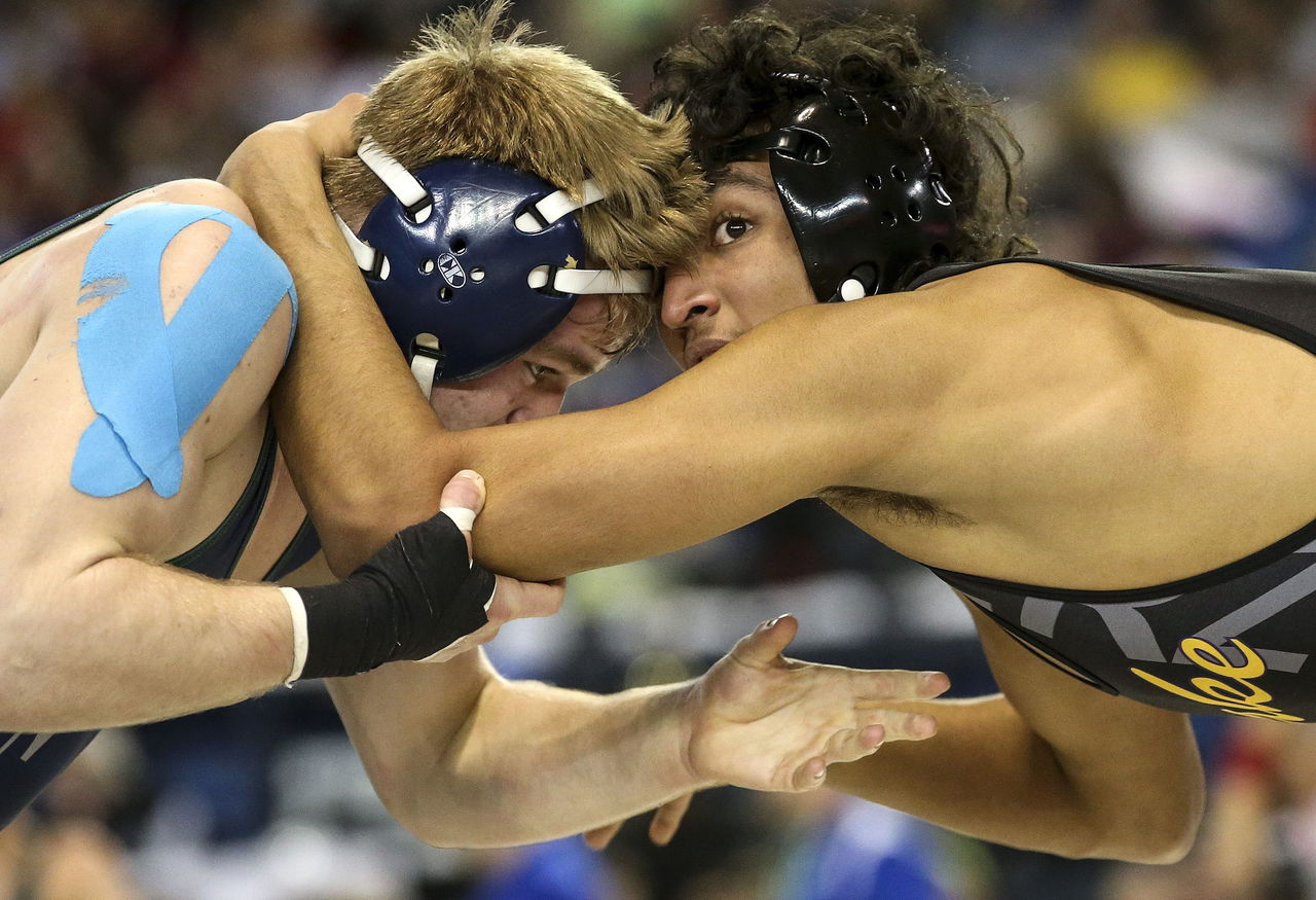 Lake Stevens’ Trysten Perales grapples with Todd Beamer’s Sean Van Earwage during a 145-pound match in the second round of Mat Classic XXVIII on Friday at the Tacoma Dome.