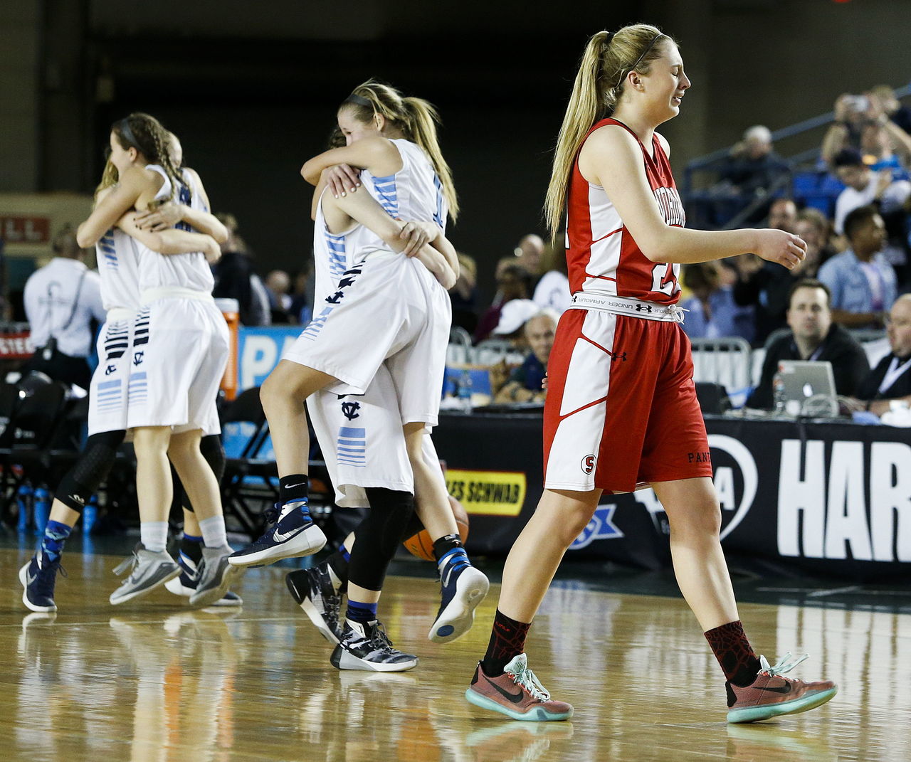 Snohomish’s Madison Pollock (right) walks off the court as Central Valley players celebrate their 57-48 victory in the 4A state championship game at the Tacoma Dome on Saturday.