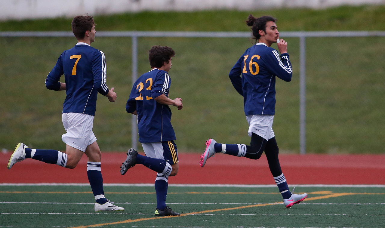 Mariner’s Abdulkader Al-Bayati (right) hushes the crowd after scoring a goal during a match against Snohomish on Tuesday in Snohomish.