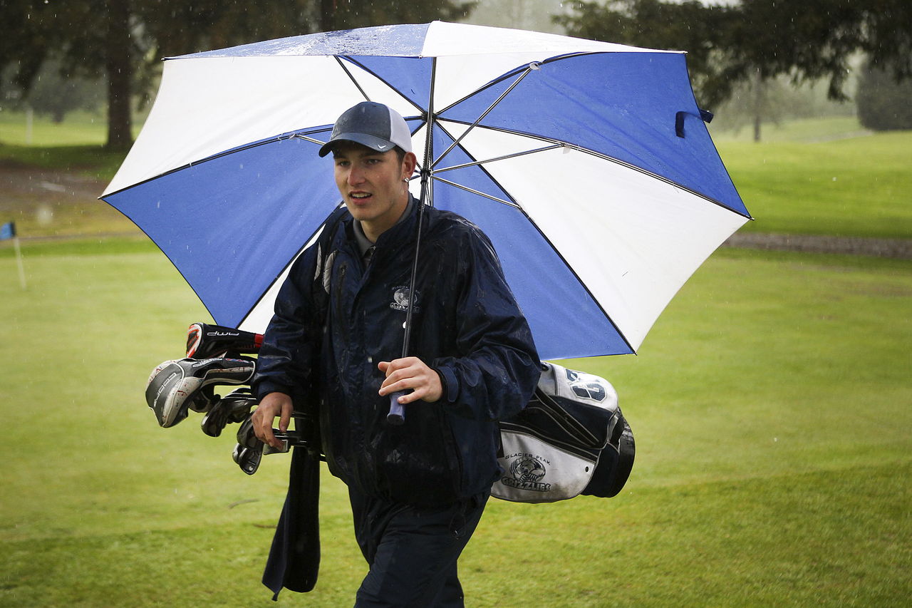 Glacier Peak golfer Justin Guffey walks with his clubs during a team practice earlier this month at Kenwanda Golf Course in Snohomish.
