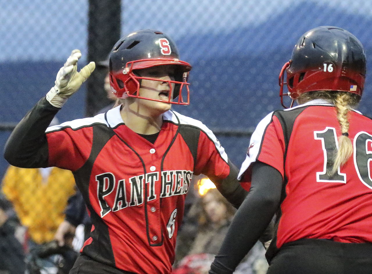 Snohomish’s Alyssa Simons (left) is congratulated by teammate Carmen Morrison after scoring a run Friday against Monroe.