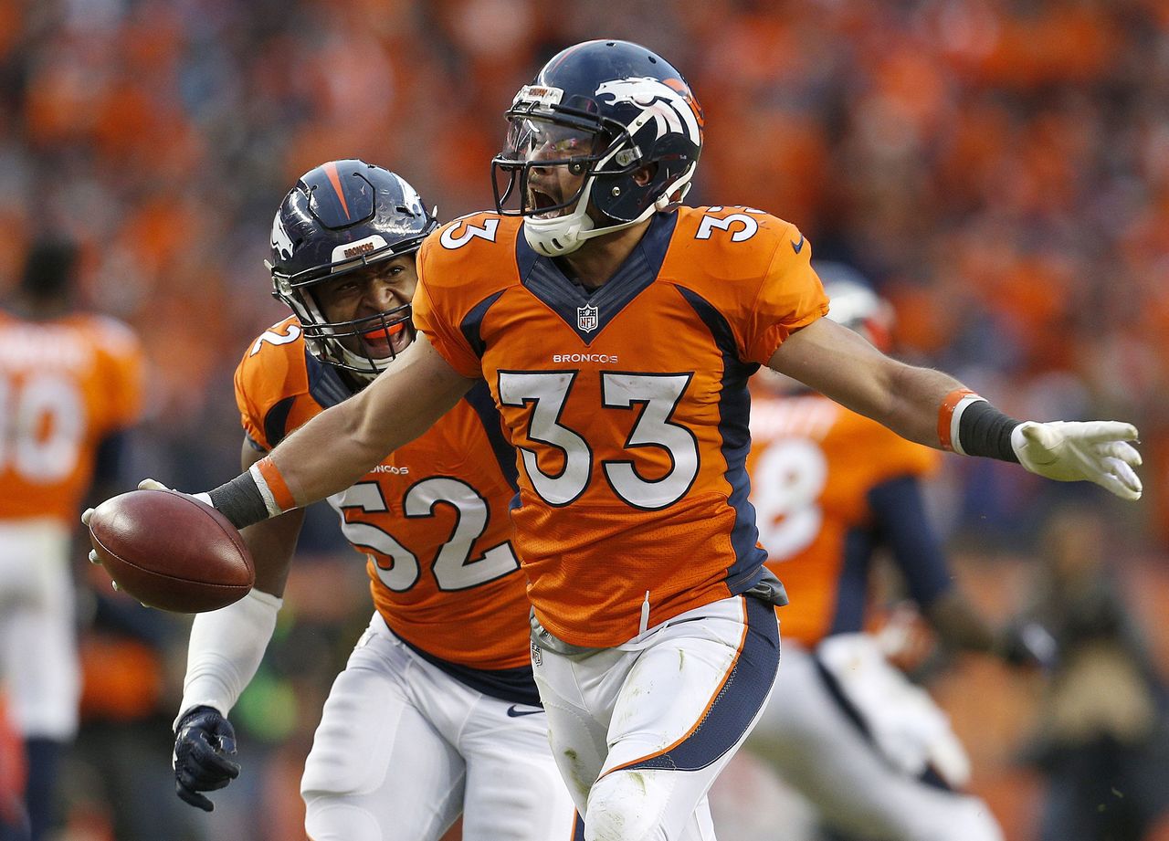 The Broncos’ Shiloh Keo (33) celebrates with Corey Nelson after recovering an onside kick to seal the win in the AFC Championship Game against the Patriots on Jan. 24 in Denver.