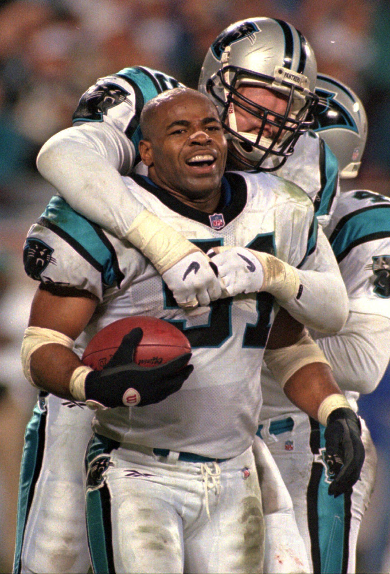 Panthers linebacker Sam Mills (front) celebrates with teammate Matt Elliott after his interception against the Cowboys during a game in 1997. The Panthers’ motto “Keep pounding” comes from Mills who died of intestinal cancer on April 18, 2005 at the age of 45.