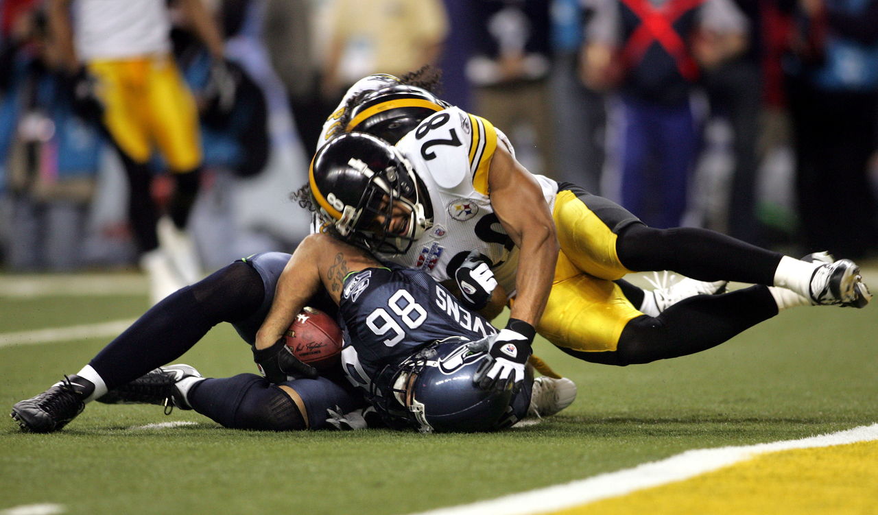 The Seahawks’ Jerramy Stevens is tackled by Pittsburgh’s Chris Hope and Troy Polamalu (rear) during Super Bowl XL on Feb. 2, 2006 in Detroit.
