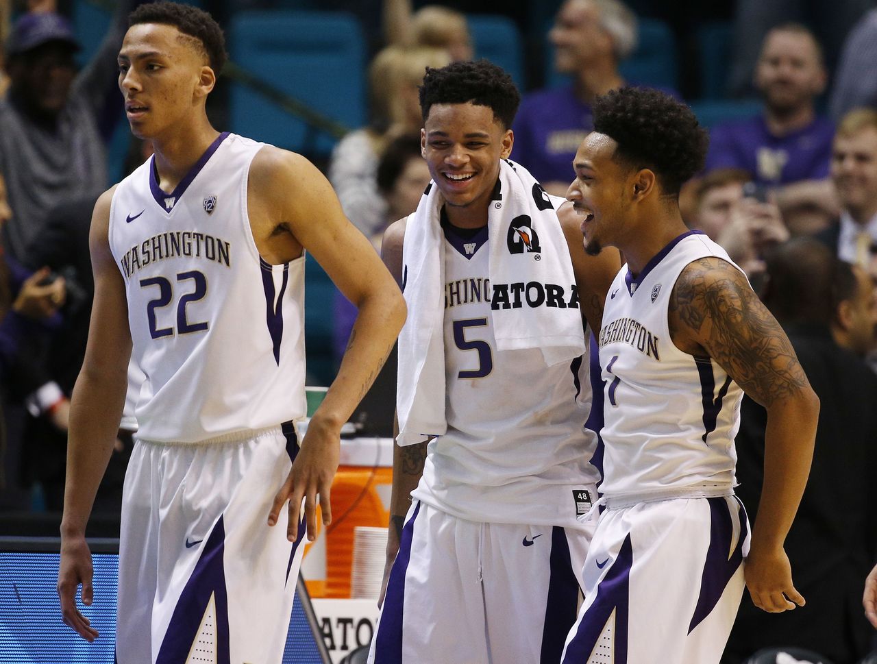 Washington forward Dominic Green (left) guard Dejounte Murray (center) and guard David Crisp react after defeating Stanford 91-68 in an NCAA college basketball game in the first round of the Pac-12 tournament Wednesday in Las Vegas.