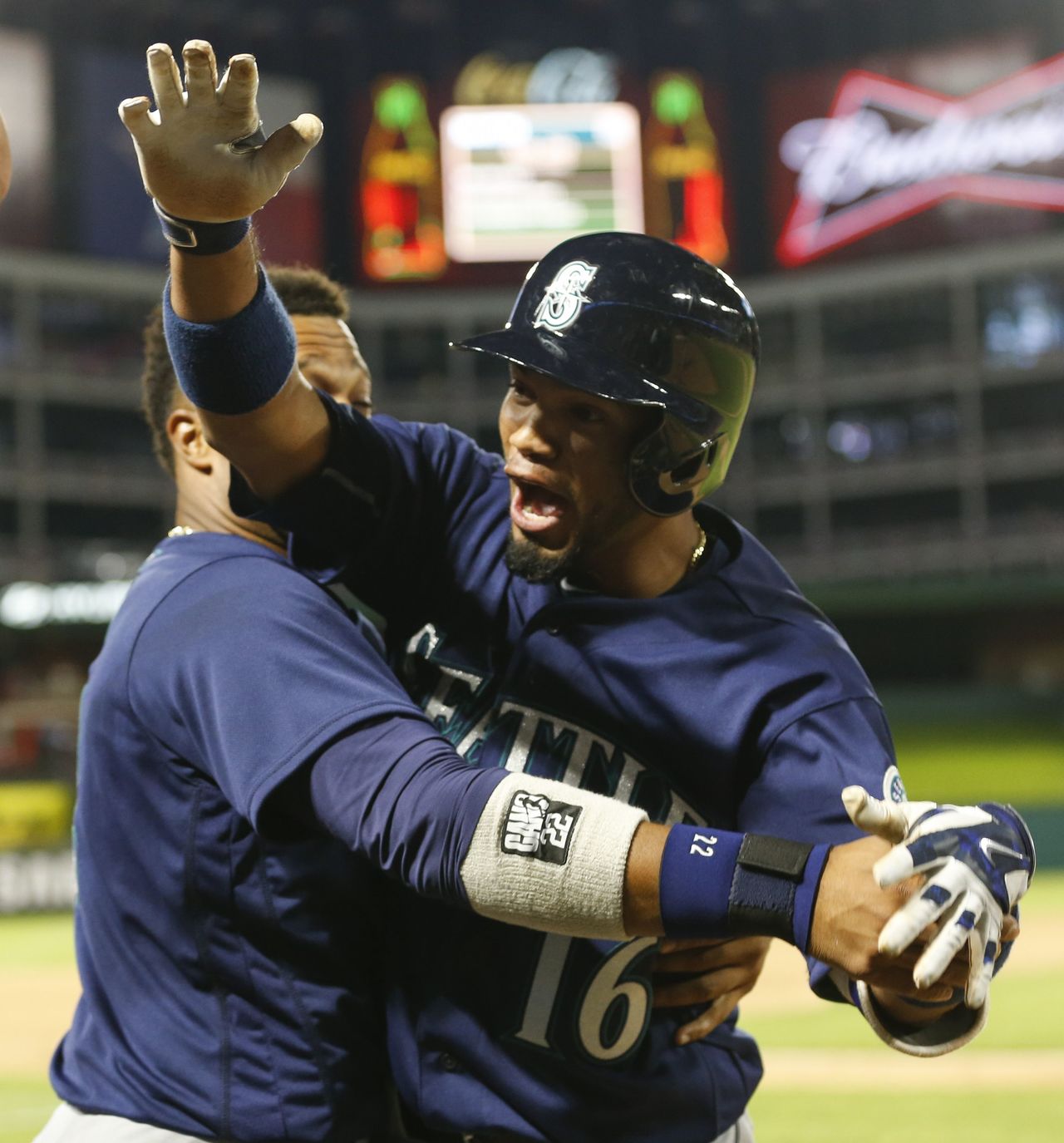 The Mariners’ Luis Sardinas (16) celebrates his two-run home run with Robinson Cano against the Rangers on Tuesday in Arlington, Texas.