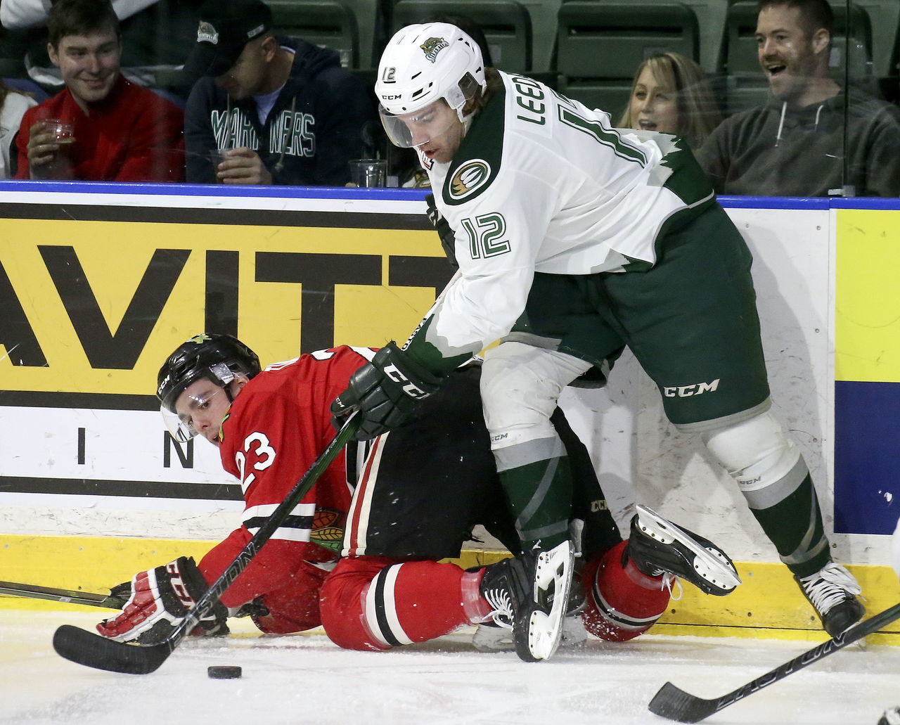 Silvertips captain Dawson Leedahl battles for the puck with the Winterhawks’ Dominic Turgeon during a playoff game March 25 at Xfinity Arena.
