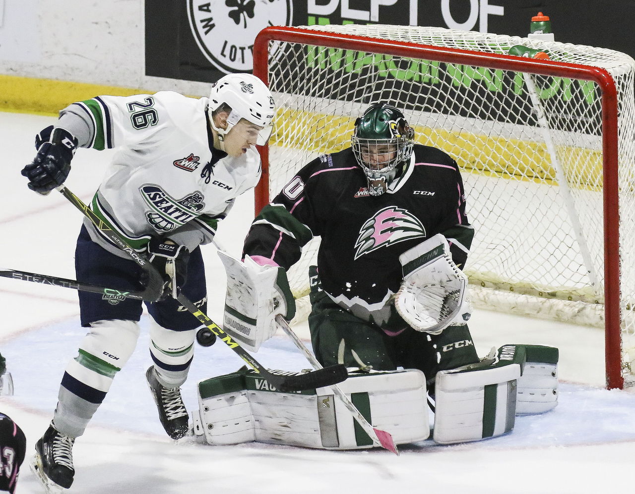 Seattle’s Nolan Volcan (26) challenges Everett goaltender Carter Hart during a game in October at Xfinity Arena.