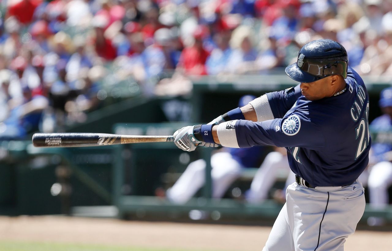 Seattle Mariners’ Robinson Cano (22) connects for a two-run home run in the first inning of Wednesday’s game against the Texas Rangers. Cano hit two HRs in the game.