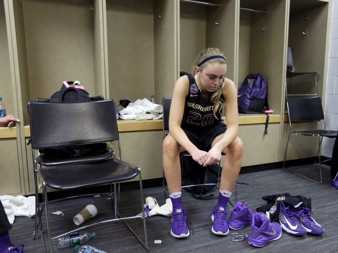 A dejected Kelli Kingma, a Jackson High School alum, sits in Washington’s locker room following the Huskies’ 80-59 loss to Syracuse in Sunday’s NCAA women’s Final Four semifinal in Indianapolis.